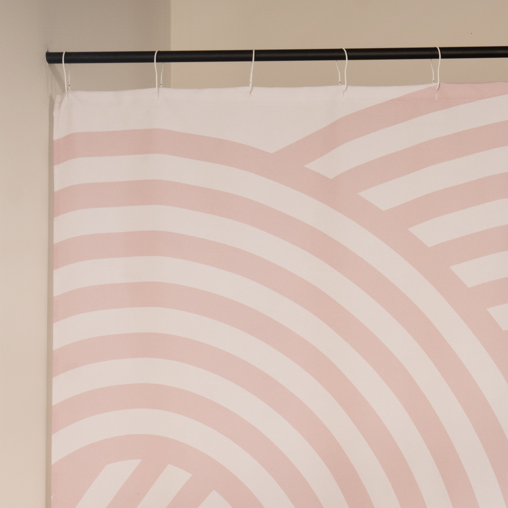 Close detail of a pink arc band meeting the cream woven ground