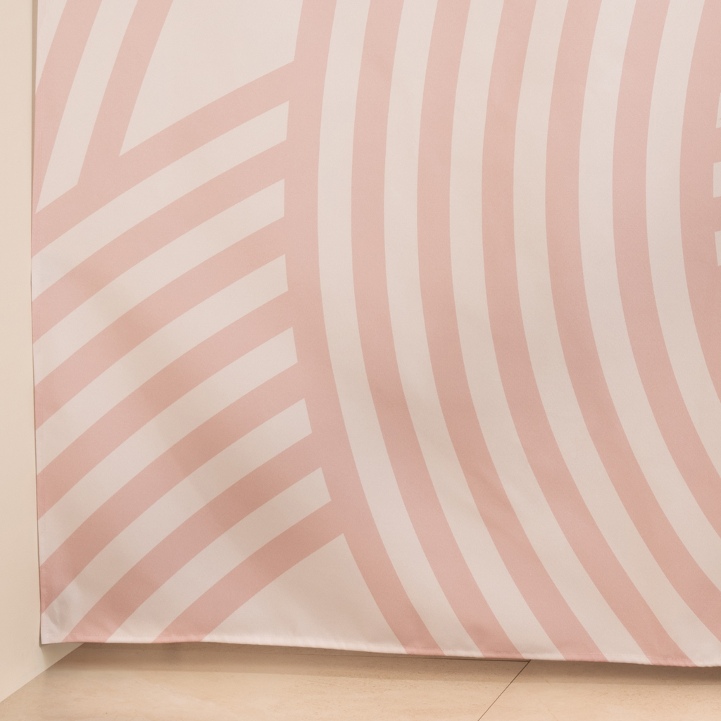 Full length pink arc curtain hanging beside a glass shower screen