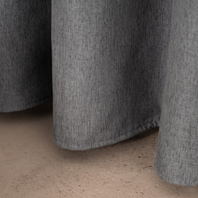 Macro view of the linen grain across the mid grey woven surface