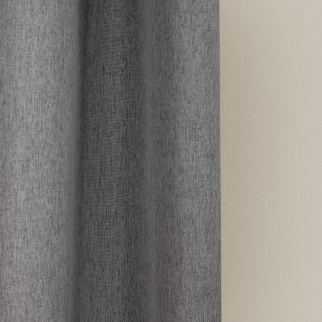 Weighted lower hem holding the plain grey panel in a straight fall