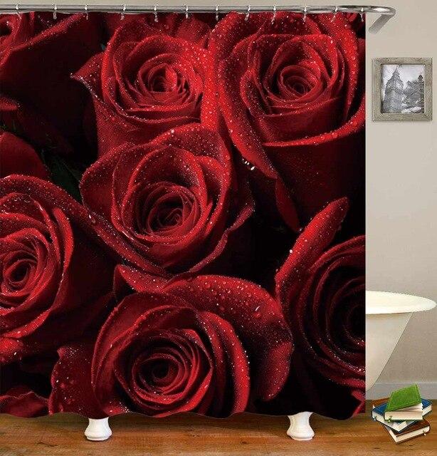Deep red roses filling the frame in close up with dew on the petals