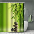 Bamboo stems beside three stacked grey pebbles on a soft green gradient