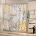 Bold yellow daisies and citrus slices among sage leaves on white