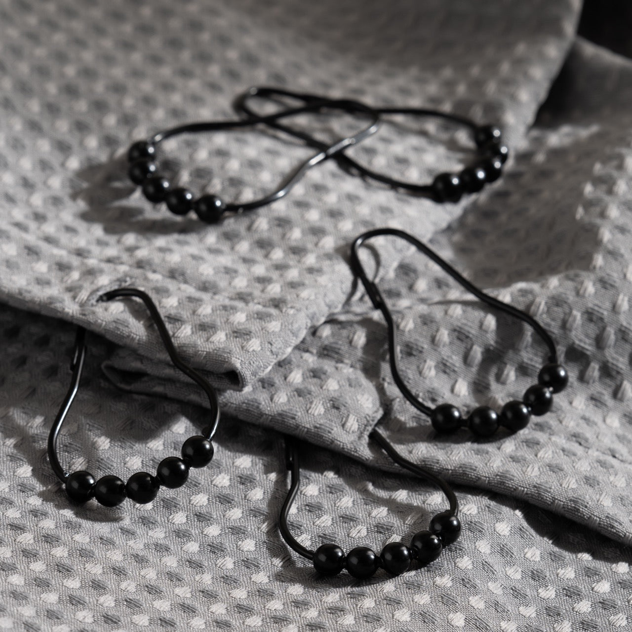 Close view of the beaded crown on a matte black curtain ring
