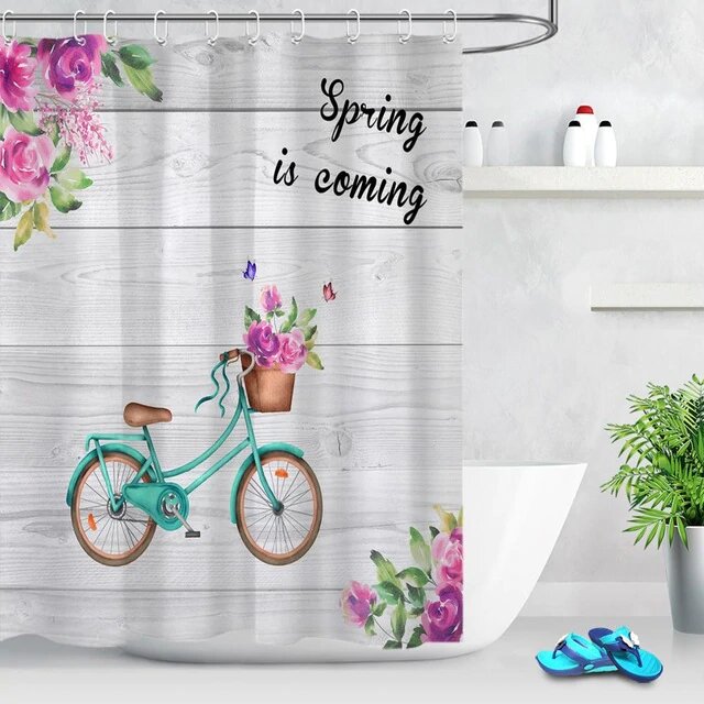 Turquoise vintage bicycle with fuchsia peonies on faded grey wood planks