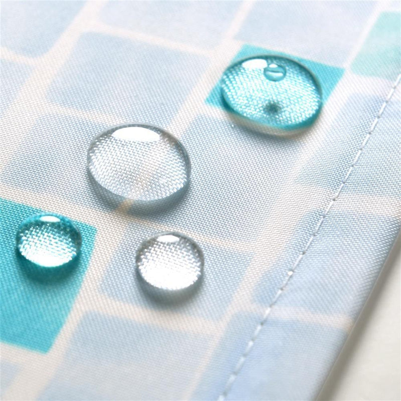 Full length seafoam mosaic curtain hanging beside a white bathtub