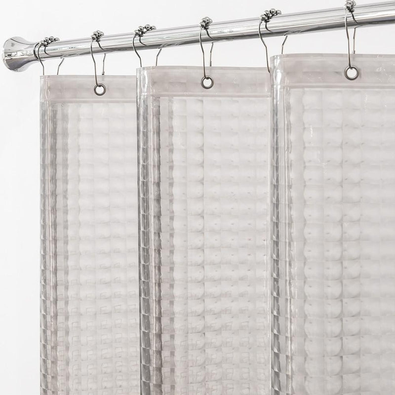 Bathtub softly visible through the frosted semi transparent curtain panel
