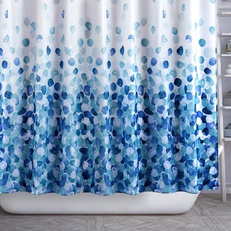 Full length white curtain hanging with its blue dot pattern on show