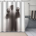 Man standing with his back turned behind a translucent panel with hands pressed