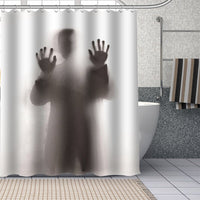 Man standing with his back turned behind a translucent panel with hands pressed