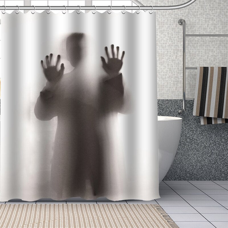 Man standing with his back turned behind a translucent panel with hands pressed
