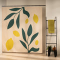Bright yellow lemons and deep green leaves on a cream ground
