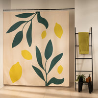 Bright yellow lemons and deep green leaves on a cream ground