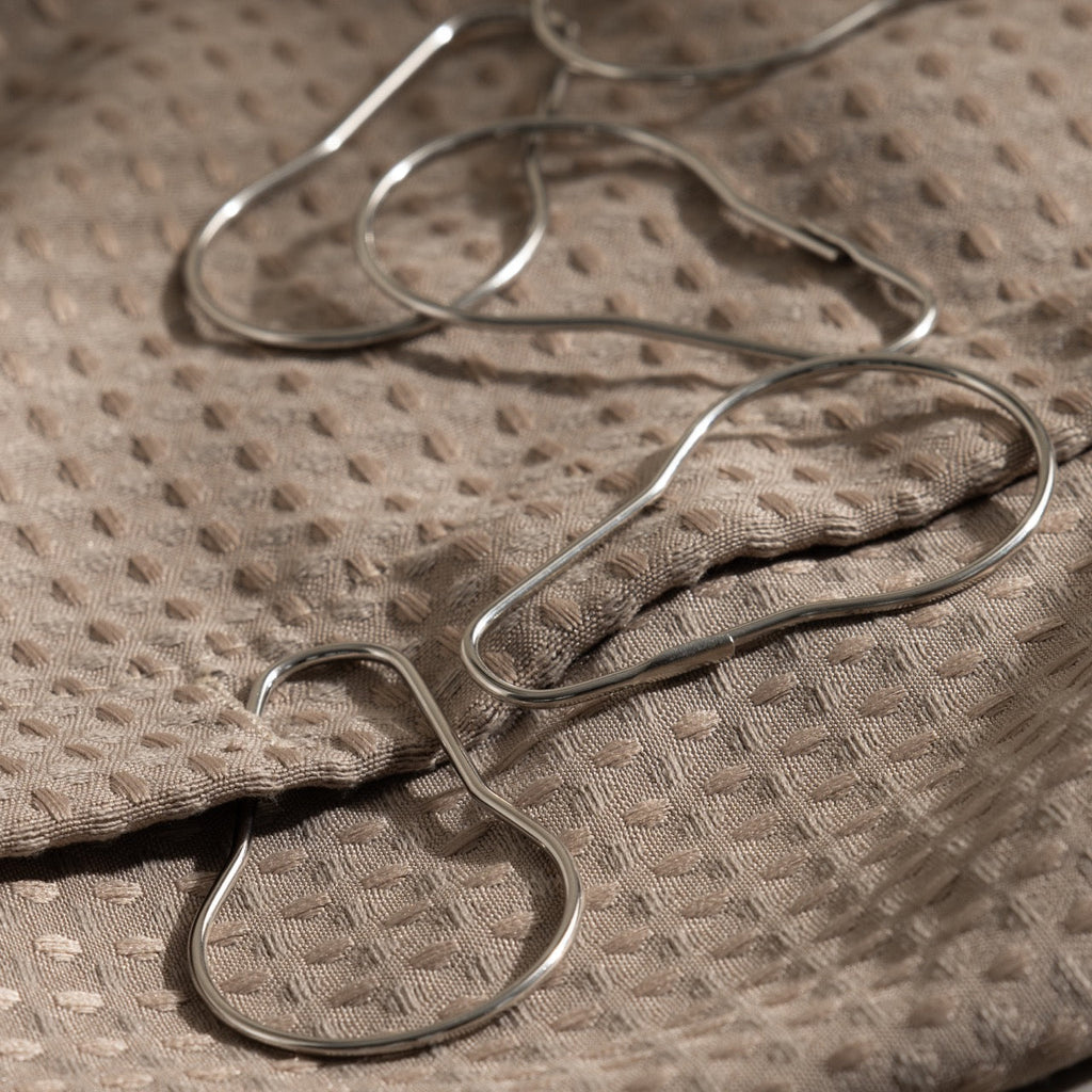 Close view of the satin silver finish on a pear shaped rail ring