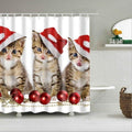 Three kittens in red Santa hats before a row of red baubles on white