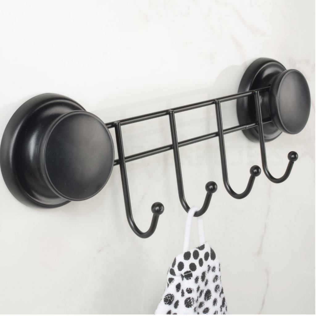 Black rack with four hooks fixed by suction cups to a tiled wall