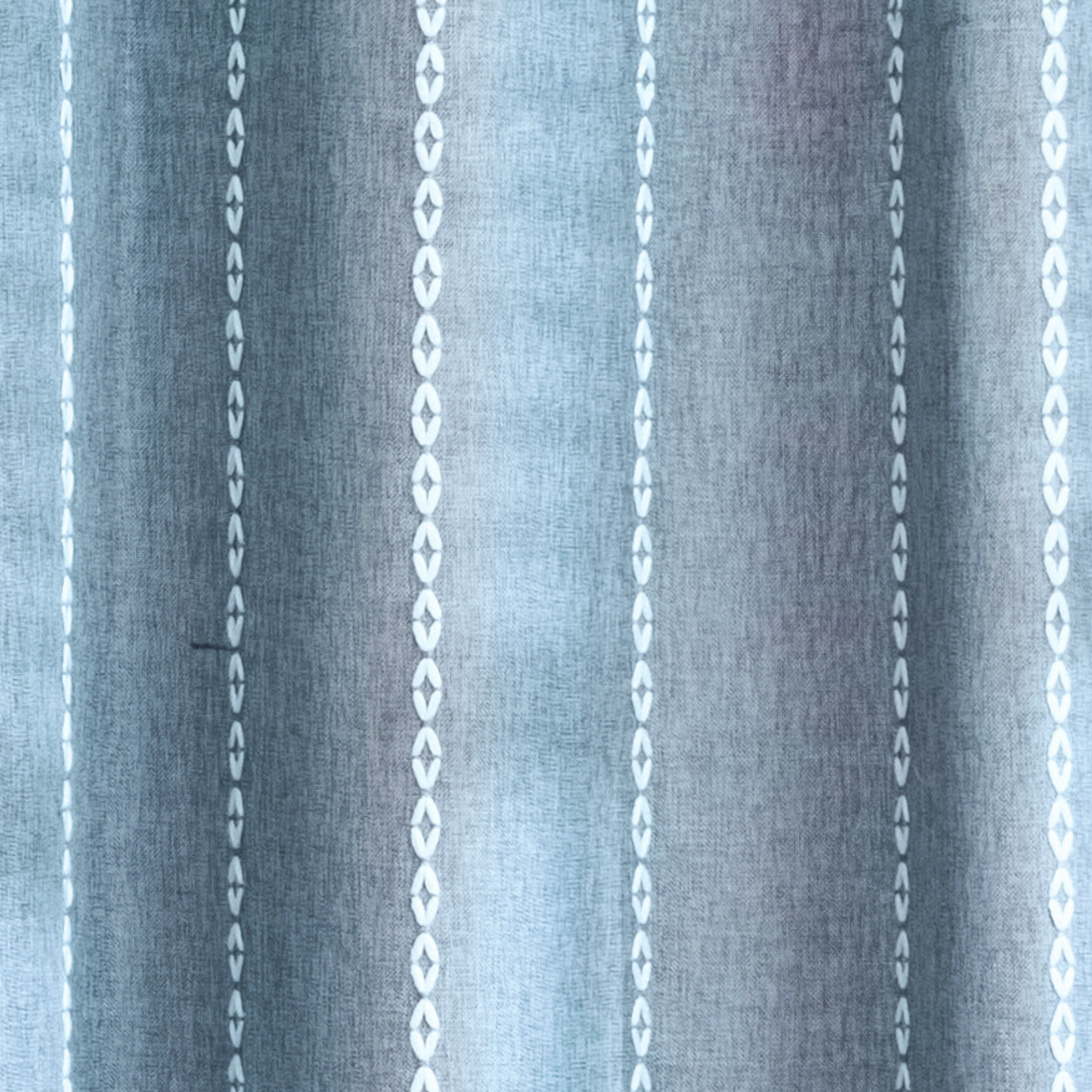 Weighted lower hem holding the blue grey panel in a straight fall