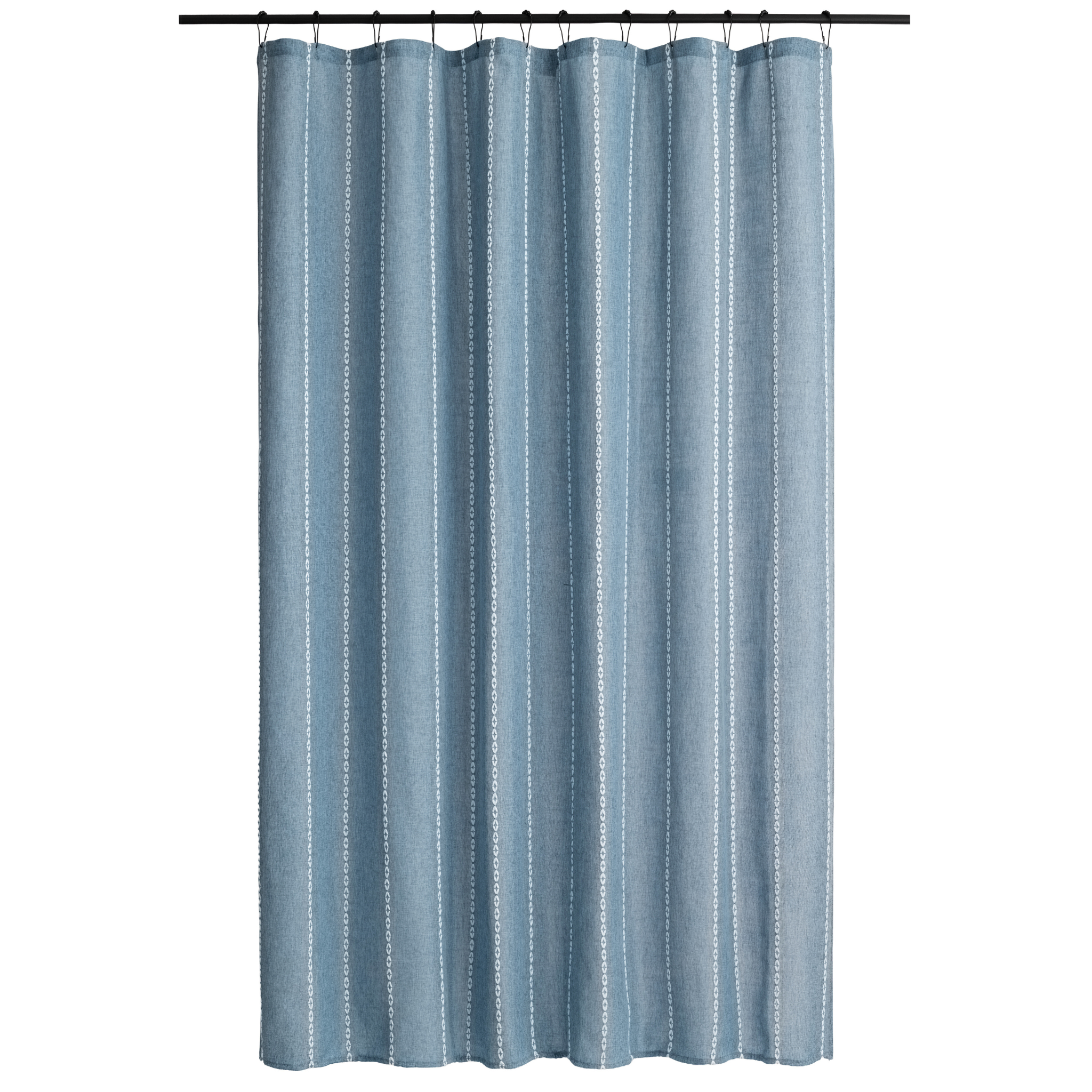 Blue grey curtain styled in a simple bathroom with pale tiling