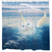 White kitten with a golden horn on a blue sky above a sea of clouds