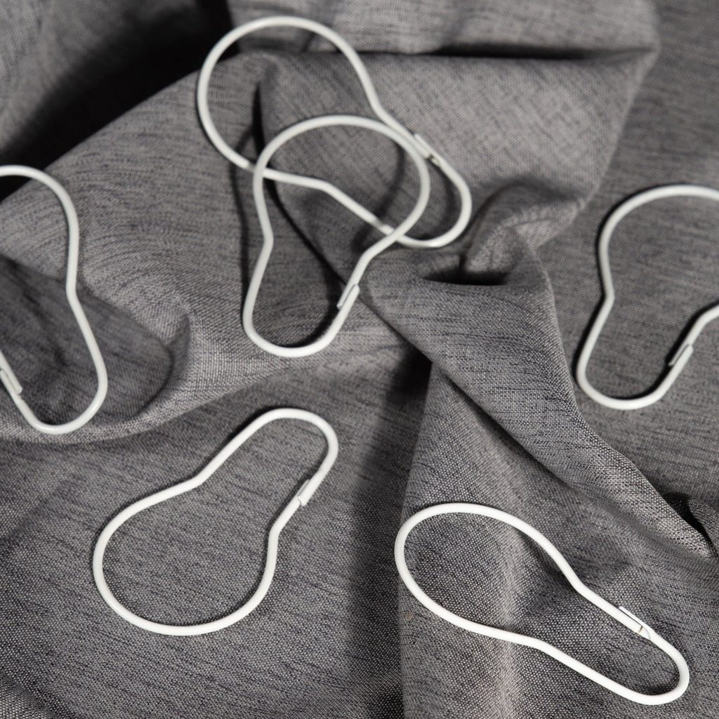 Close view of the clip closure on a plain white curtain ring