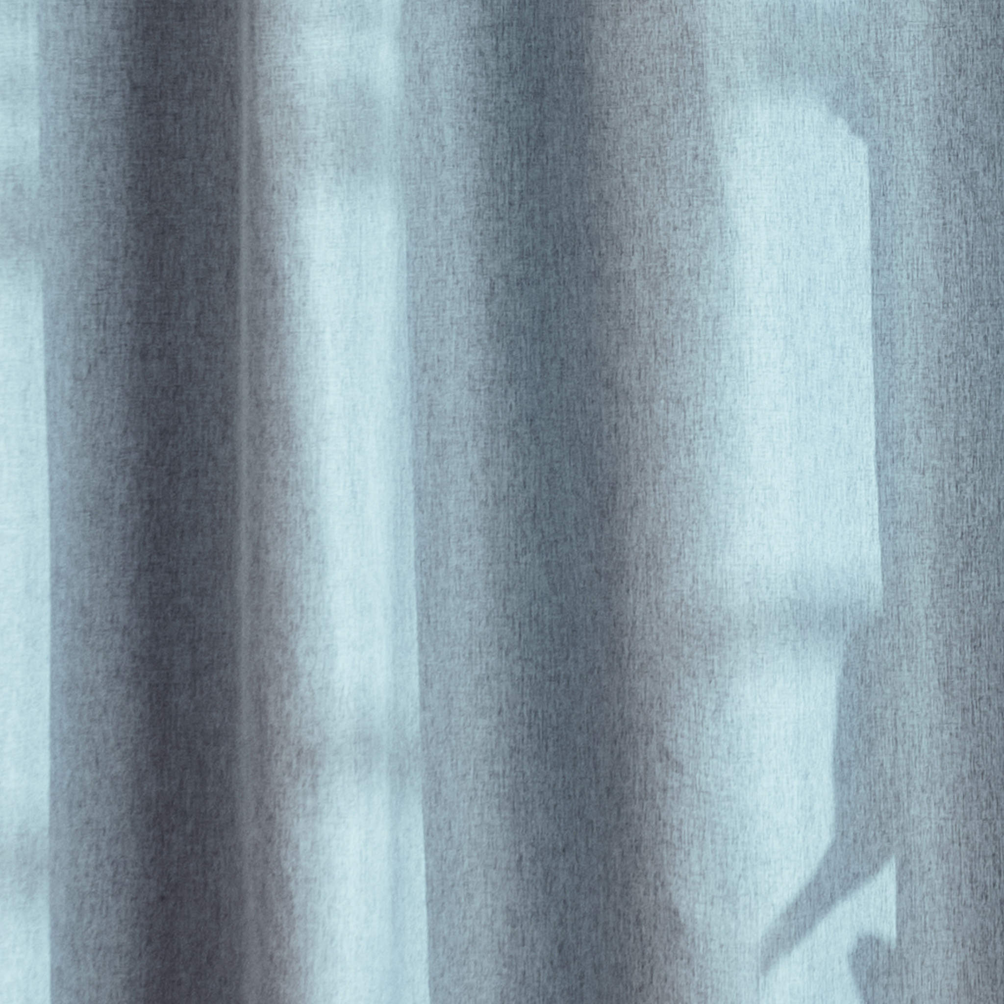 Weighted lower hem holding the blue panel in an even straight fall