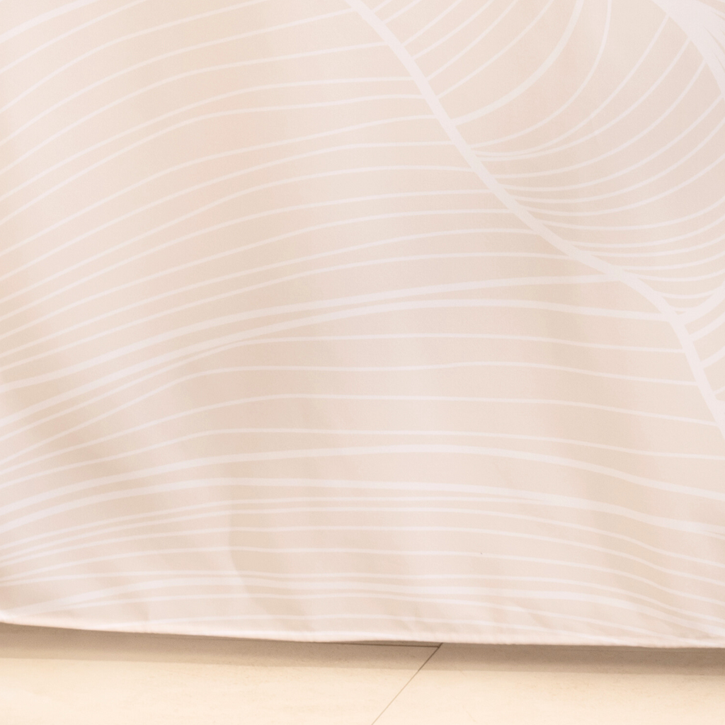 Full length pale ivory curtain hanging in a calm spa style bathroom