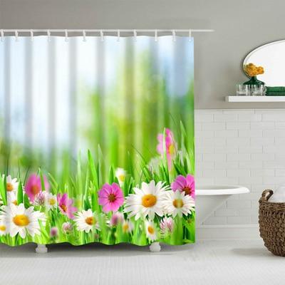 Open white daisies and pink flowers in a bright green meadow under soft bokeh