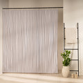 Fine even black stripes running vertically on an off-white panel