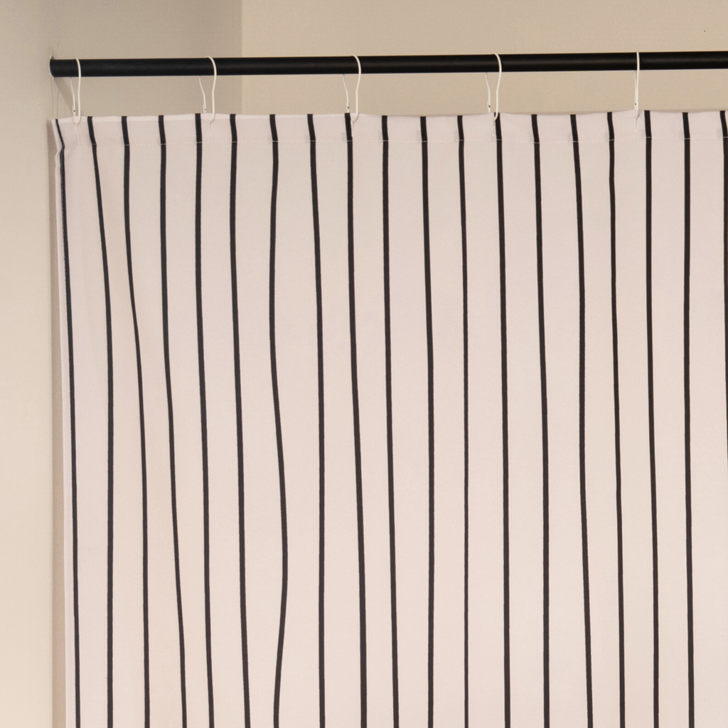 Close detail of the thin black stripes on the woven cream cloth