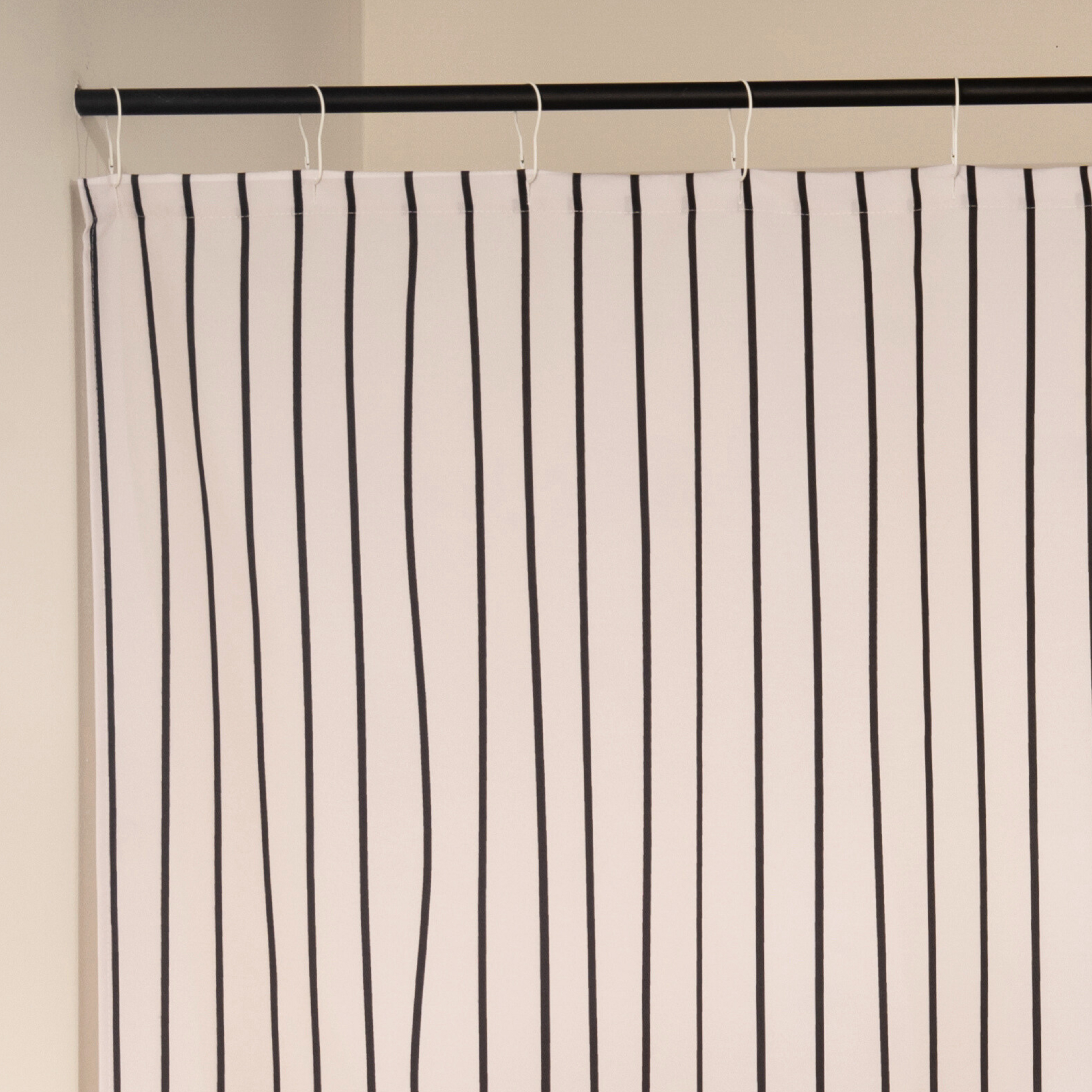 Close detail of the thin black stripes on the woven cream cloth