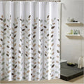 Beige brown and sage leaf sprays on white hanging in front of a bath