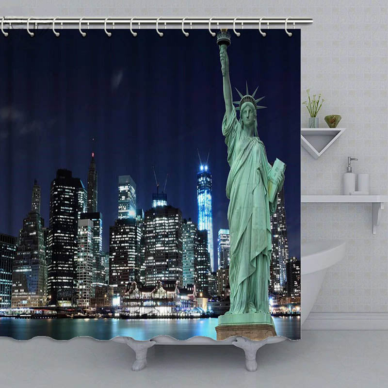 Statue of Liberty before a lit Manhattan skyline mirrored in dark water