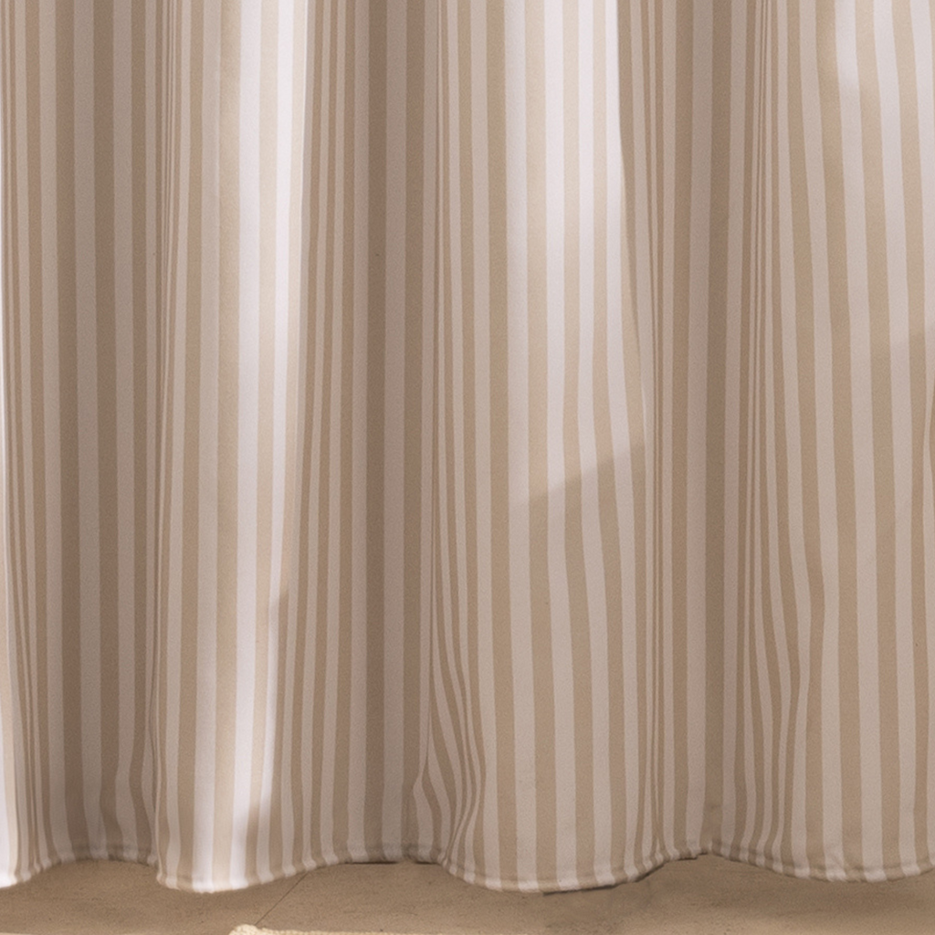 Full length beige striped curtain hanging beside a white bathtub