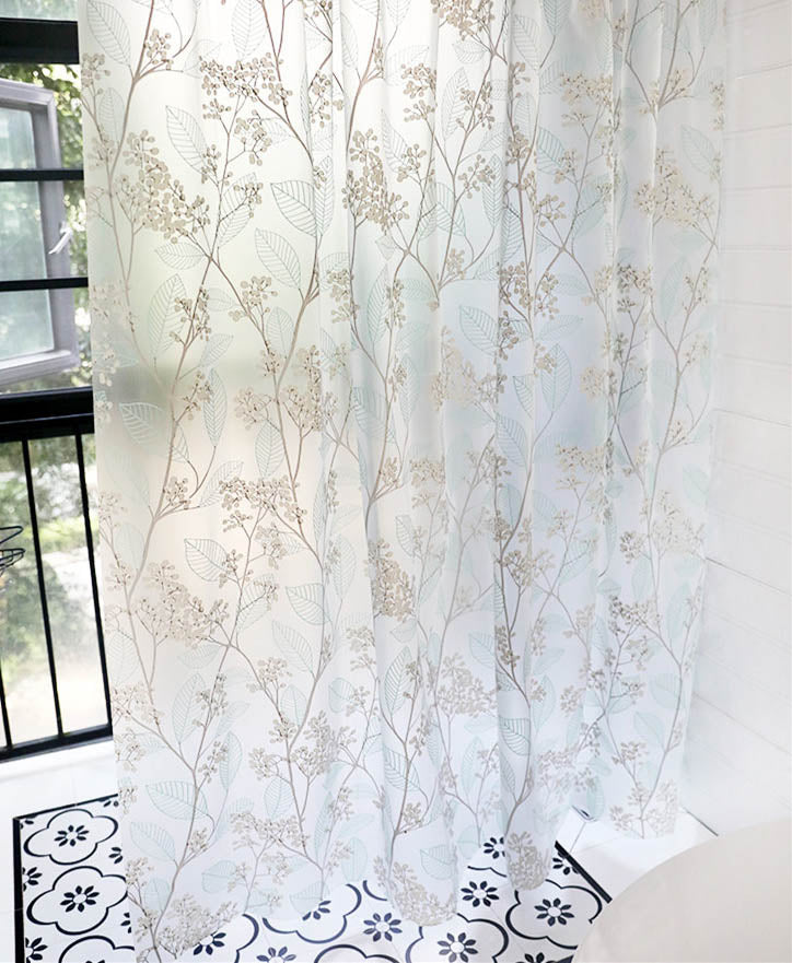 Translucent vinyl panel printed with beige grey branches letting the window show through