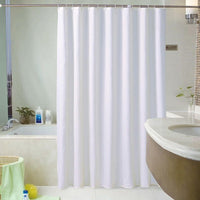 Plain white curtain panel hanging in an even fall with no pattern