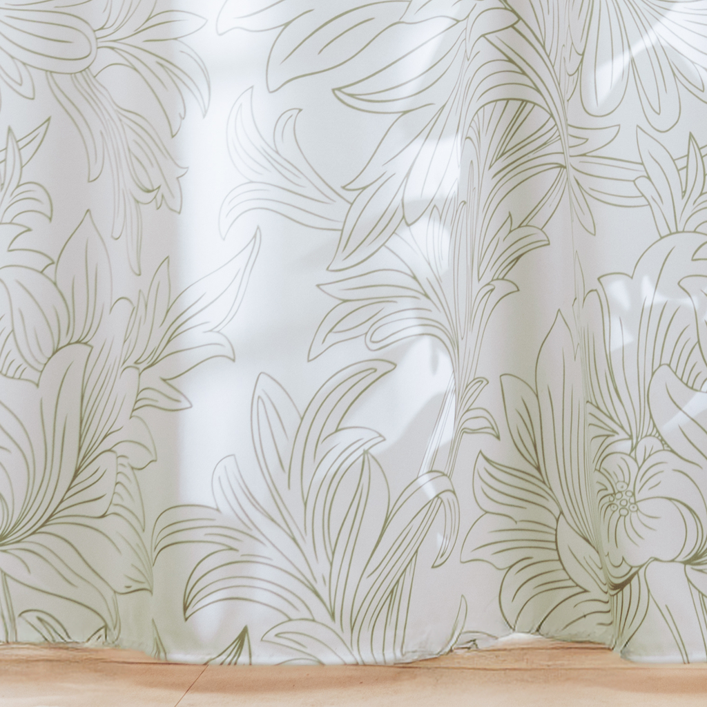Full length white on white curtain hanging beside a glass screen