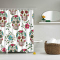 Sugar skulls decorated in pink blue and green linked by flowering green stems