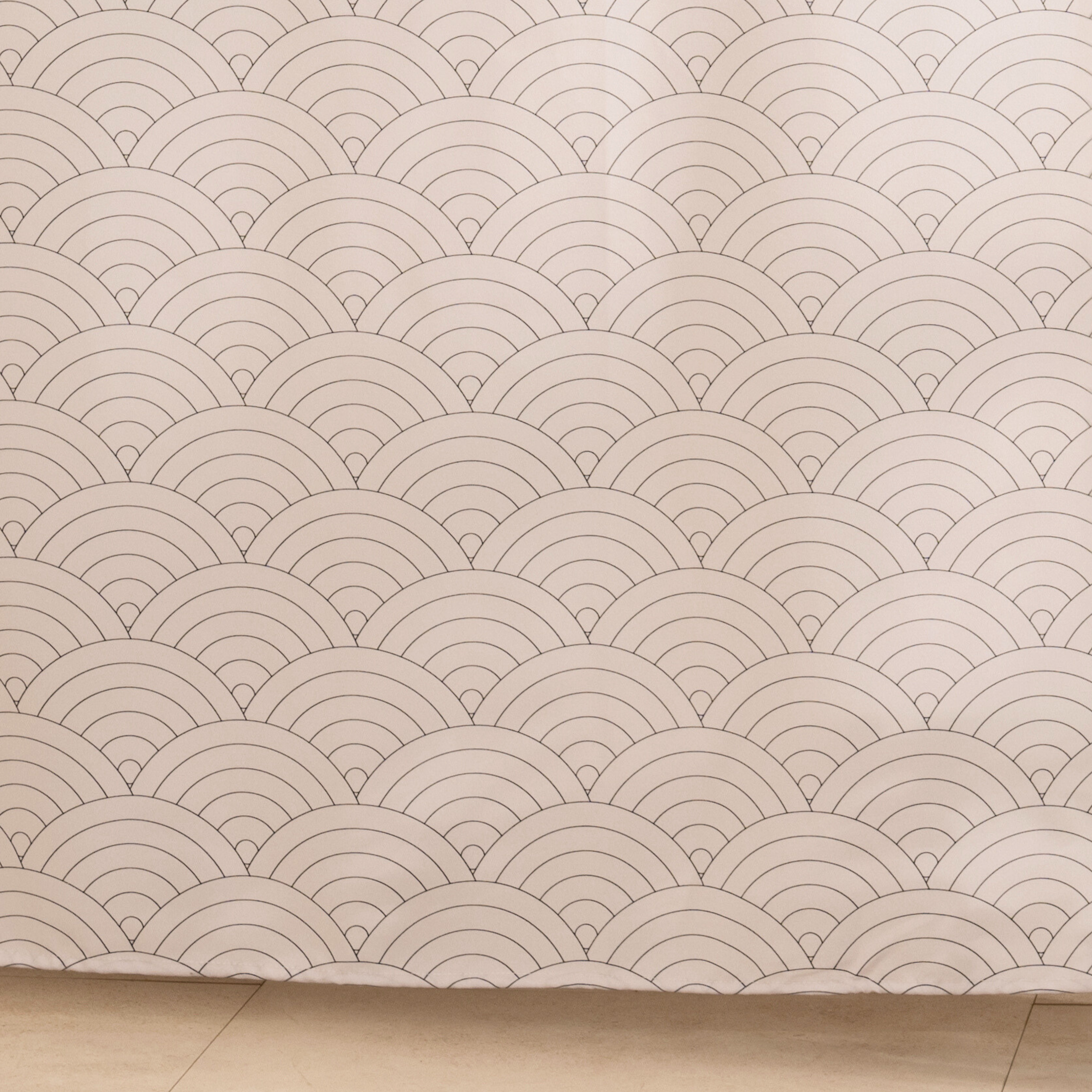 Full length textured white curtain hanging beside a glass screen