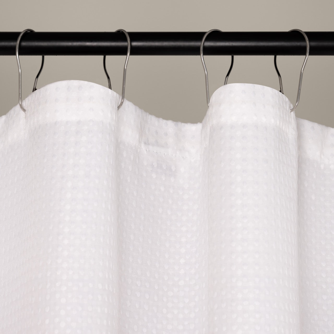 Pure white waffle panel hanging in a bright modern bathroom