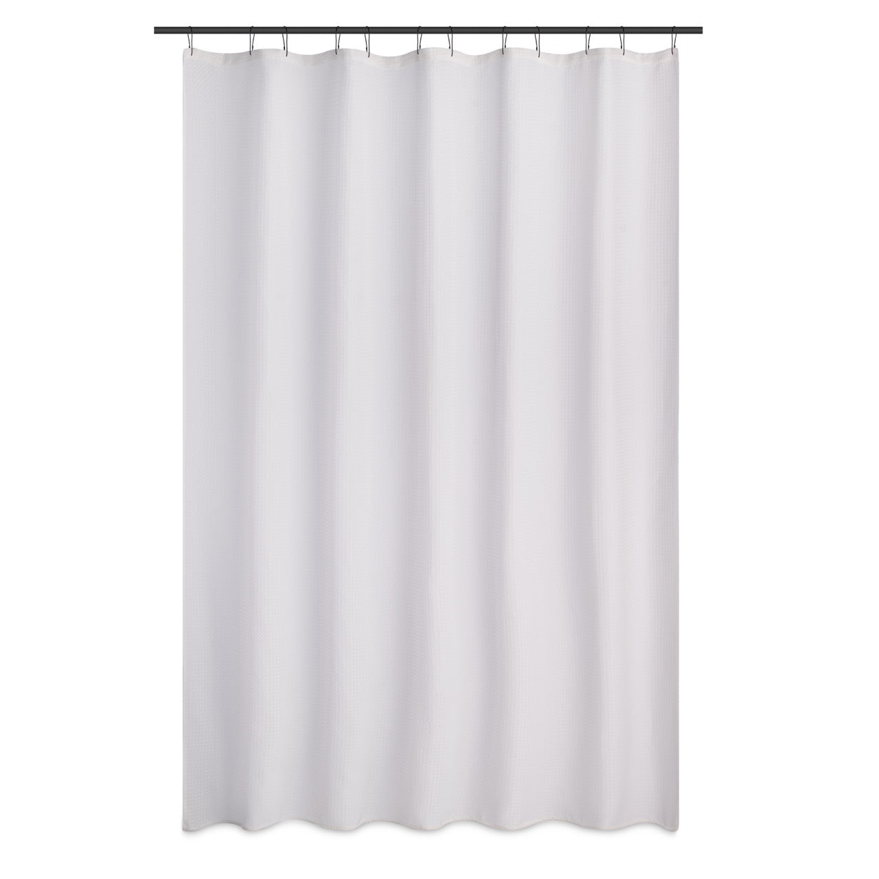 White waffle curtain styled beside a bathtub with warm daylight